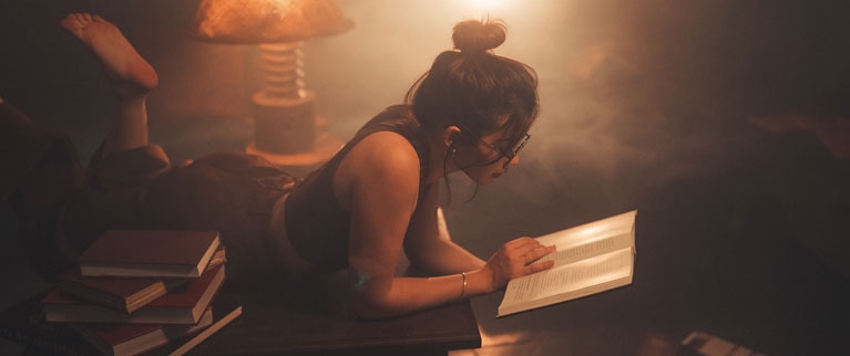 young-woman-reading-book-home